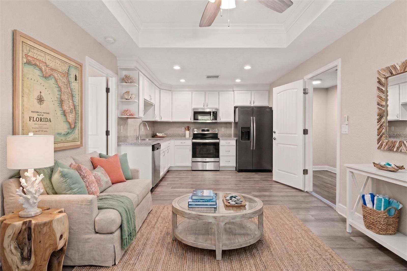 Virtually Staged Guest Living Room to Kitchen there is no dishwasher in guest kitchen area.
