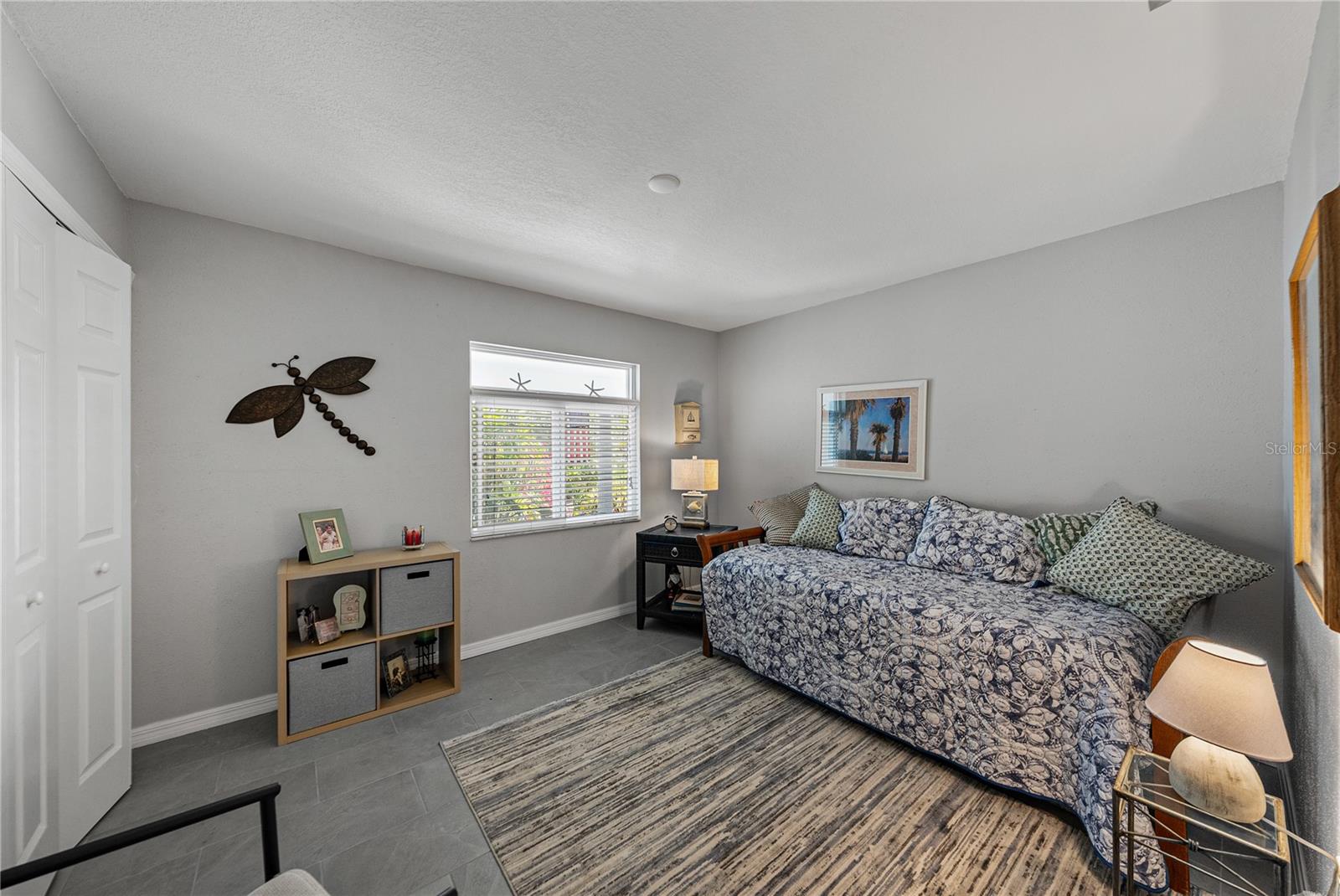 SECOND Bedroom- NEW Porcelain Tile Flooring, Fresh Paint and Hurricane Impact Window!