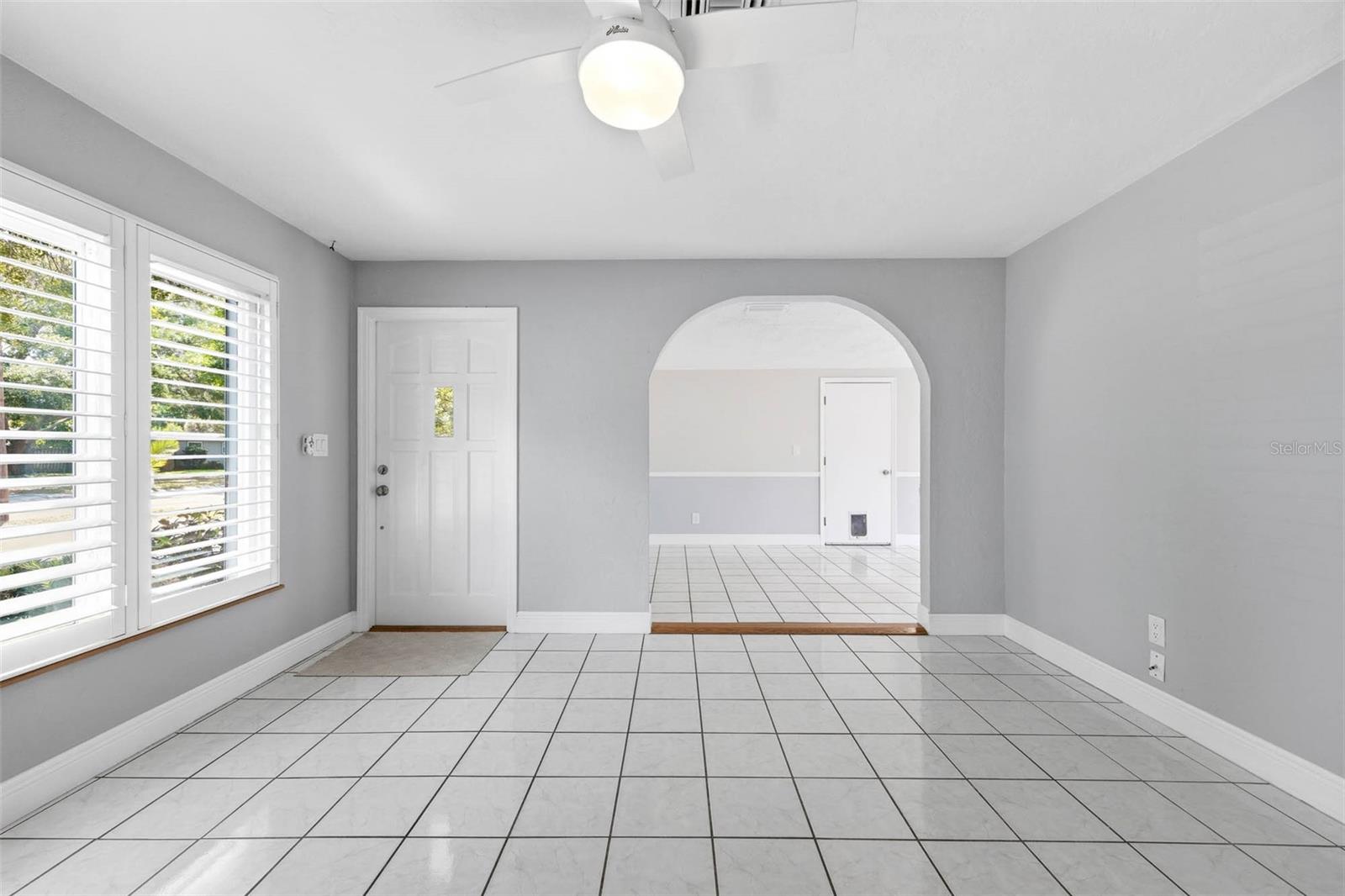 Living Room with Charming Archway leading into Dining Room
