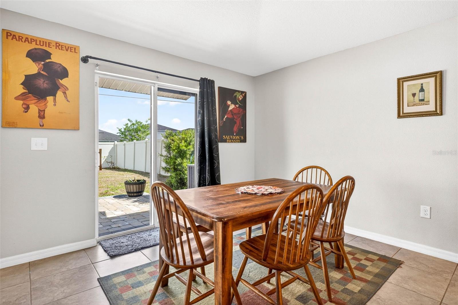 Dining room with sliding glass doors on to the pavered patio and fully fenced back yard.