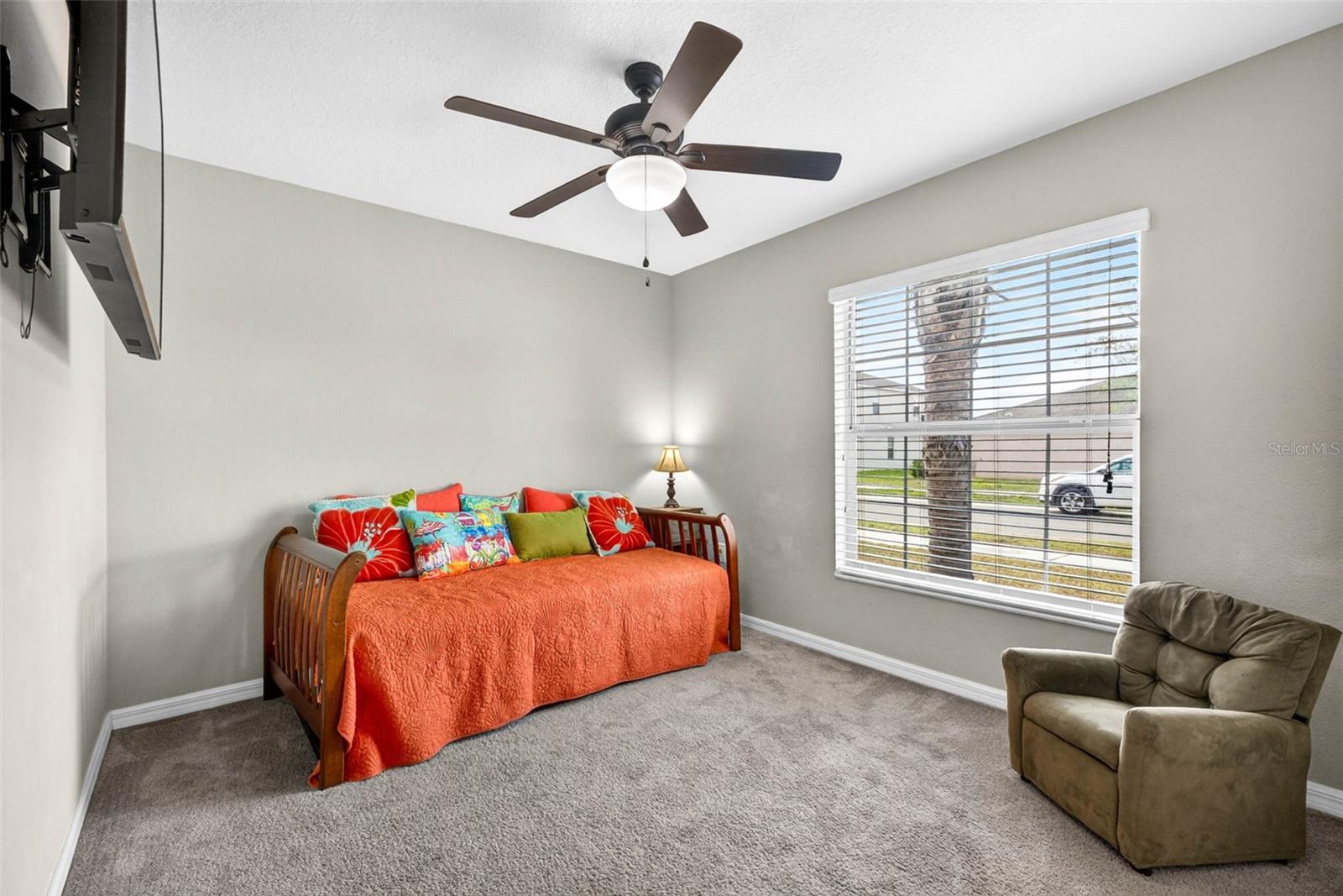 Secondary bedroom with ceiling fan and blinds