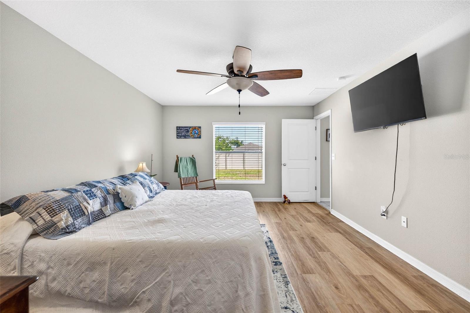 Primary bedroom with large picture window allowing lots of natural light.