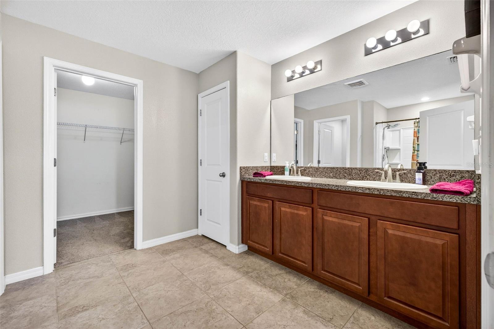 Primary bathroom with dual sinks and comfort height vanity.