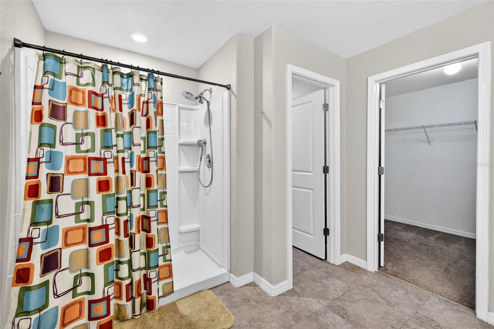 Walk in shower with built in shelves and Rain Shower head. Private water closet and large walk in closet