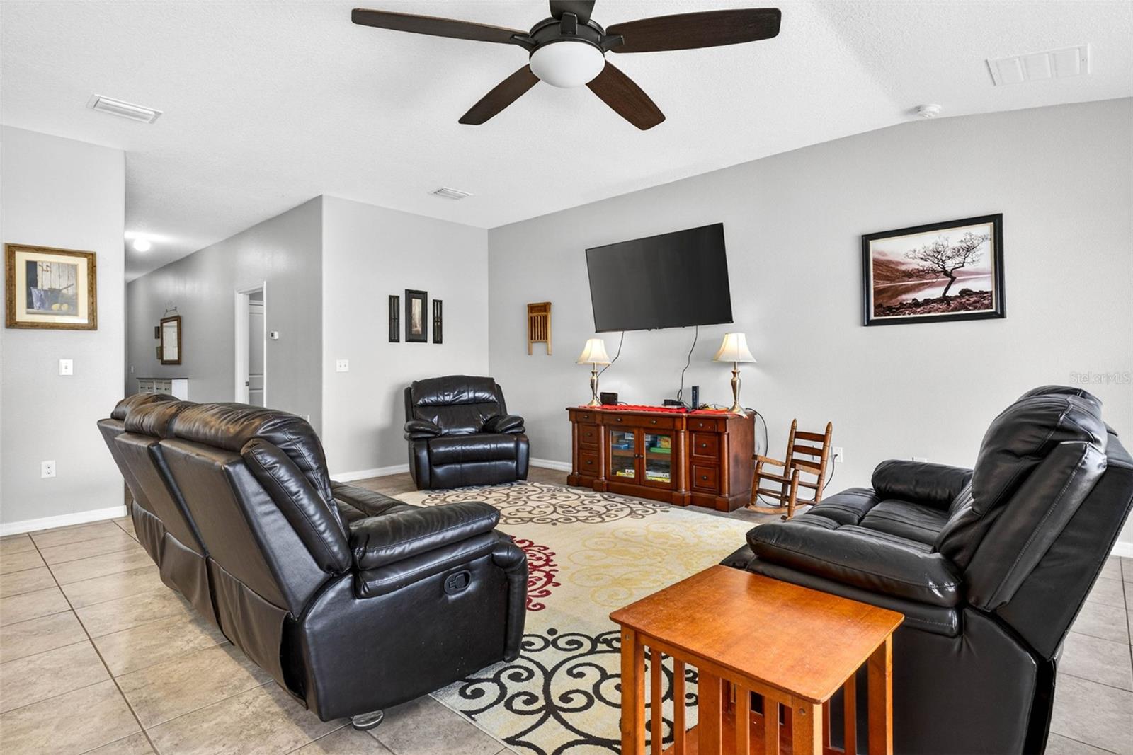 Living area with ceramic tile and ceiling fan