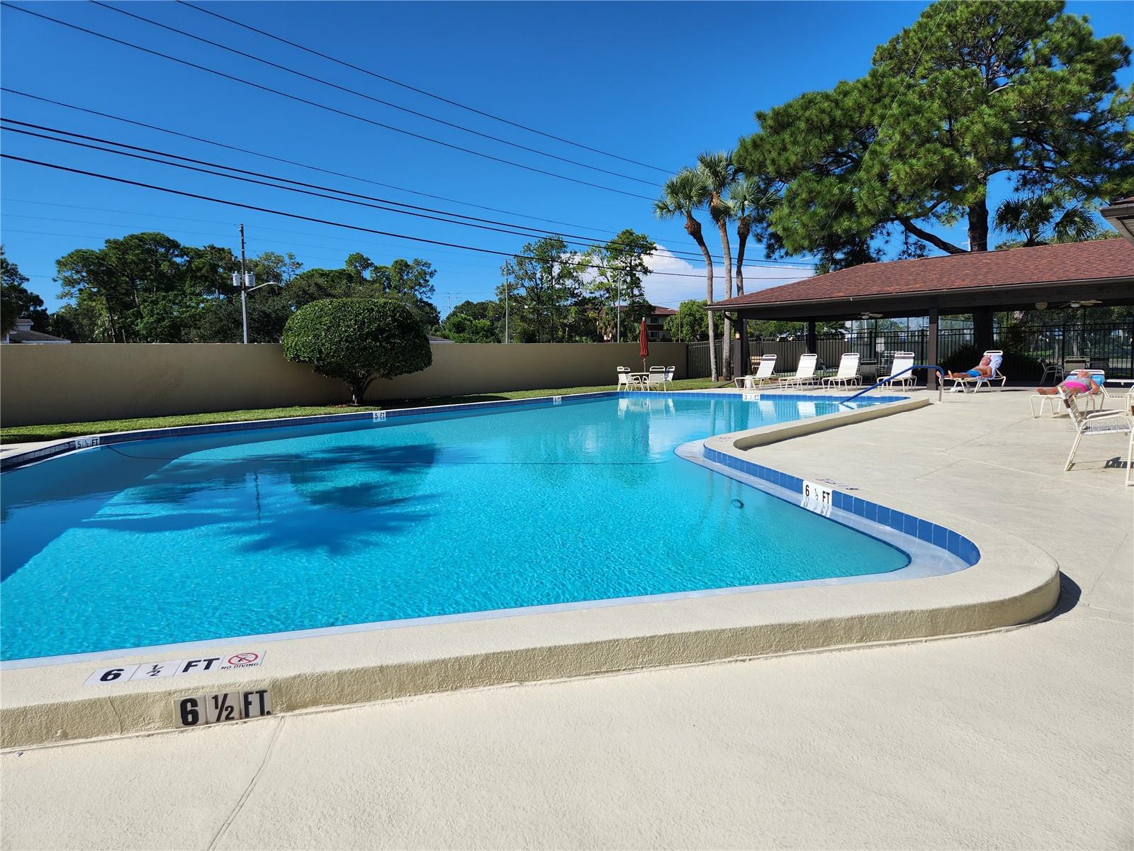 Beautiful pool with chaise lounges and tables and umbrellas for your enjoyment.  Just a walk across the parking lot to pool.