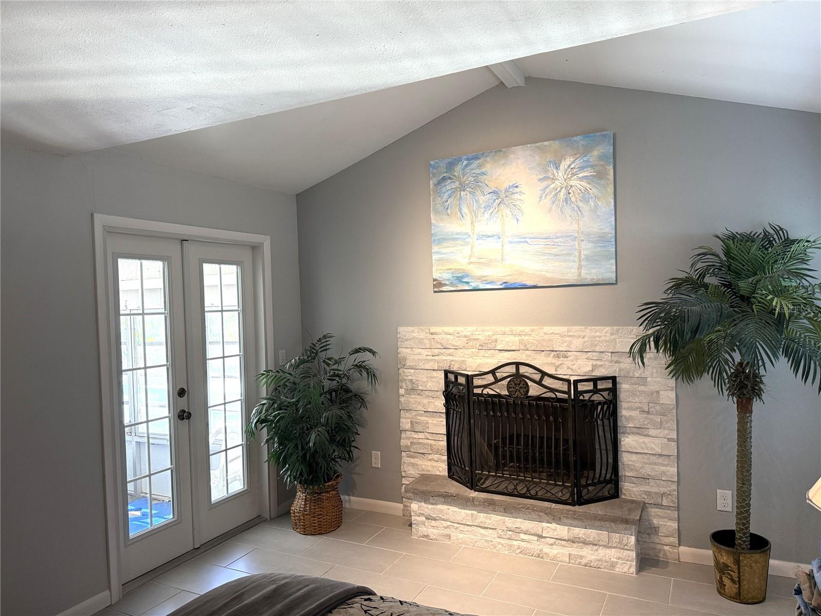 Fireplace and French doors to screened porch