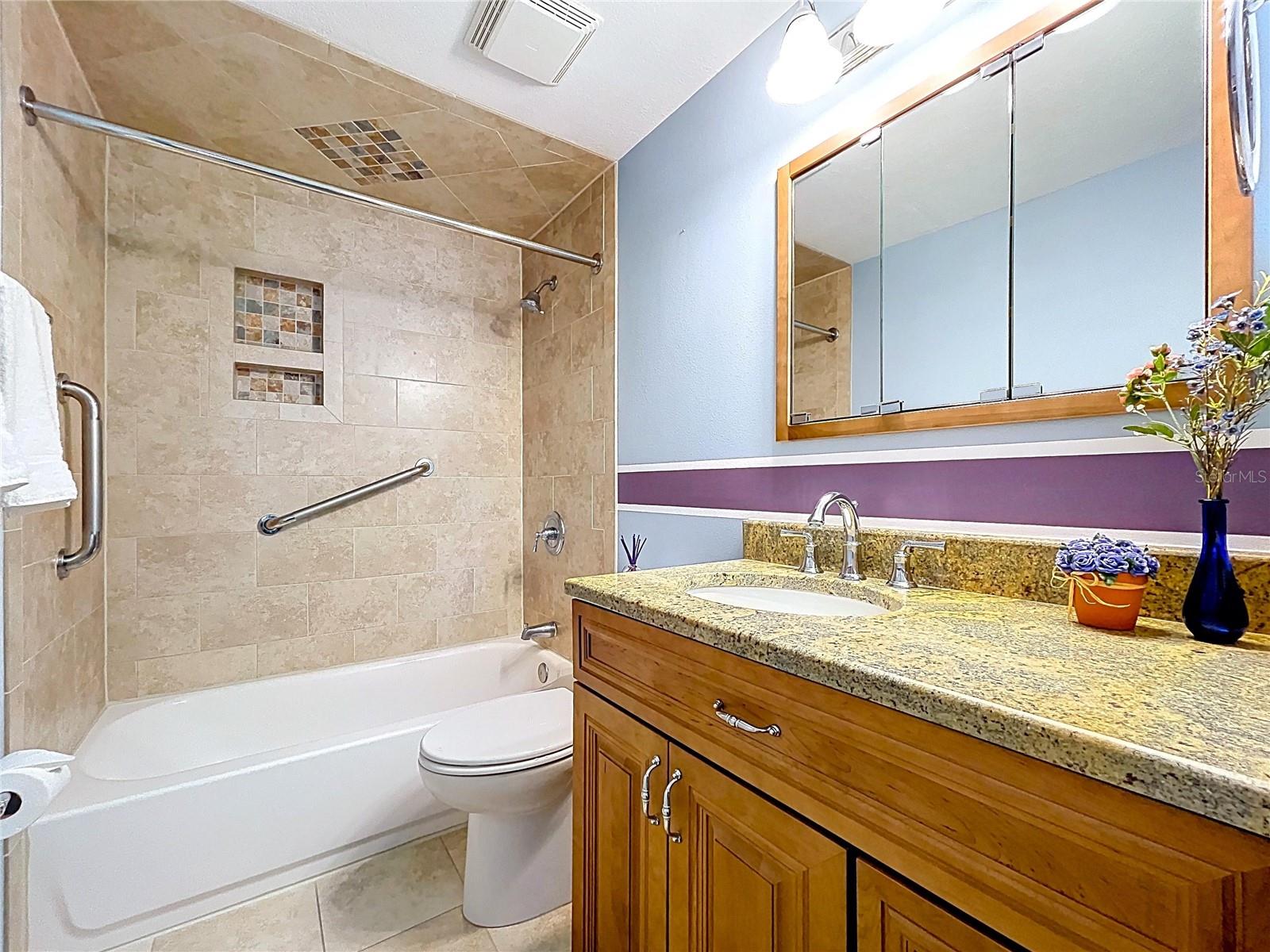 Tiled walls and ceiling over tub with shower