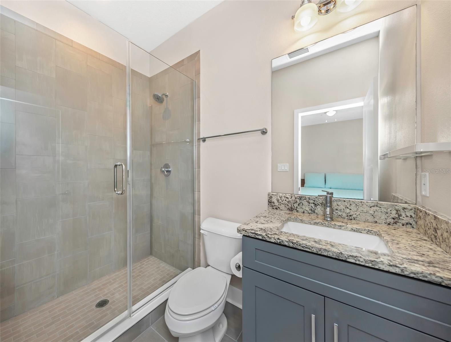 Primary bath with glass enclosed walk-in shower.