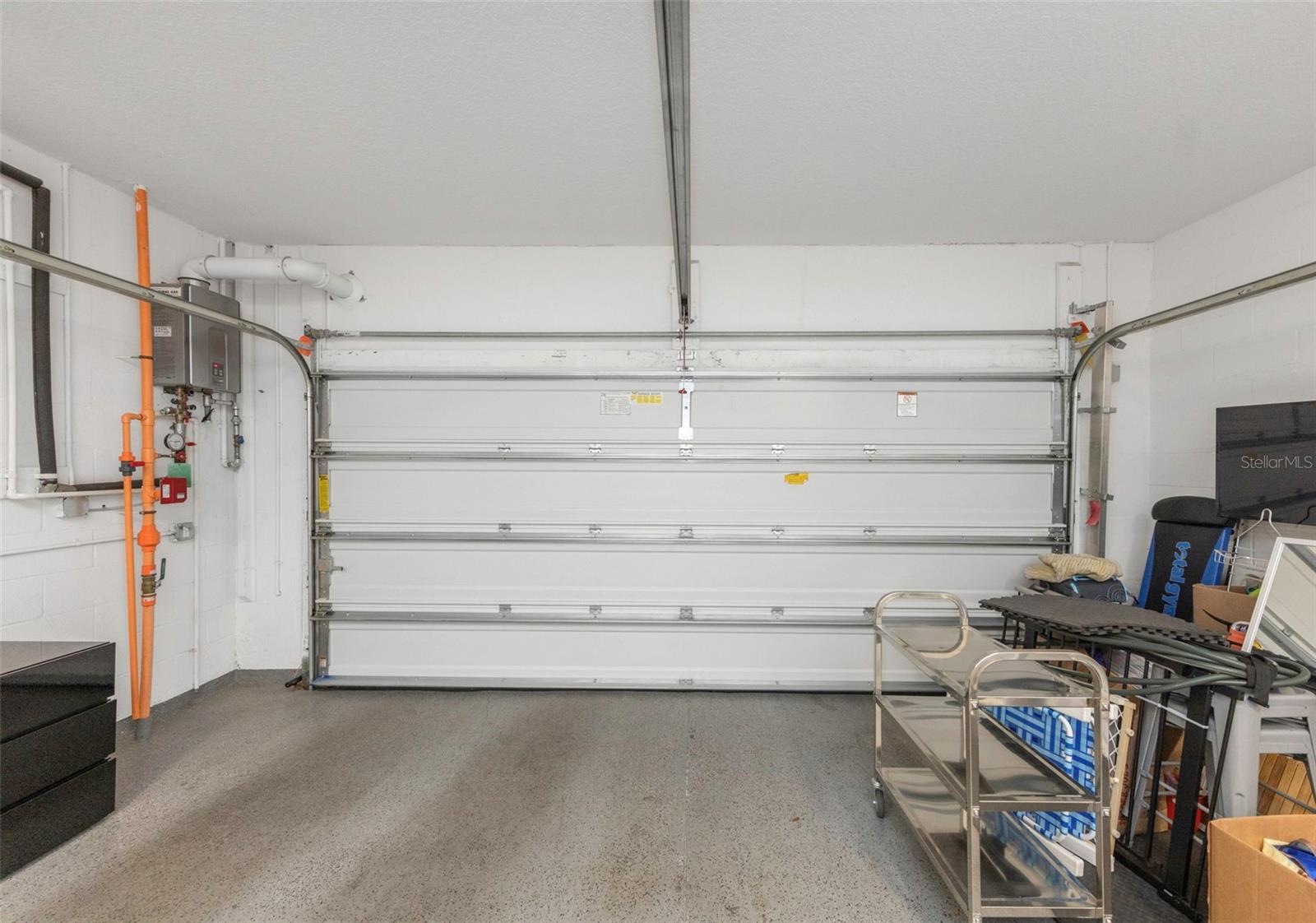 The garage houses the unit’s tankless hot water heater and fire sprinkler system.