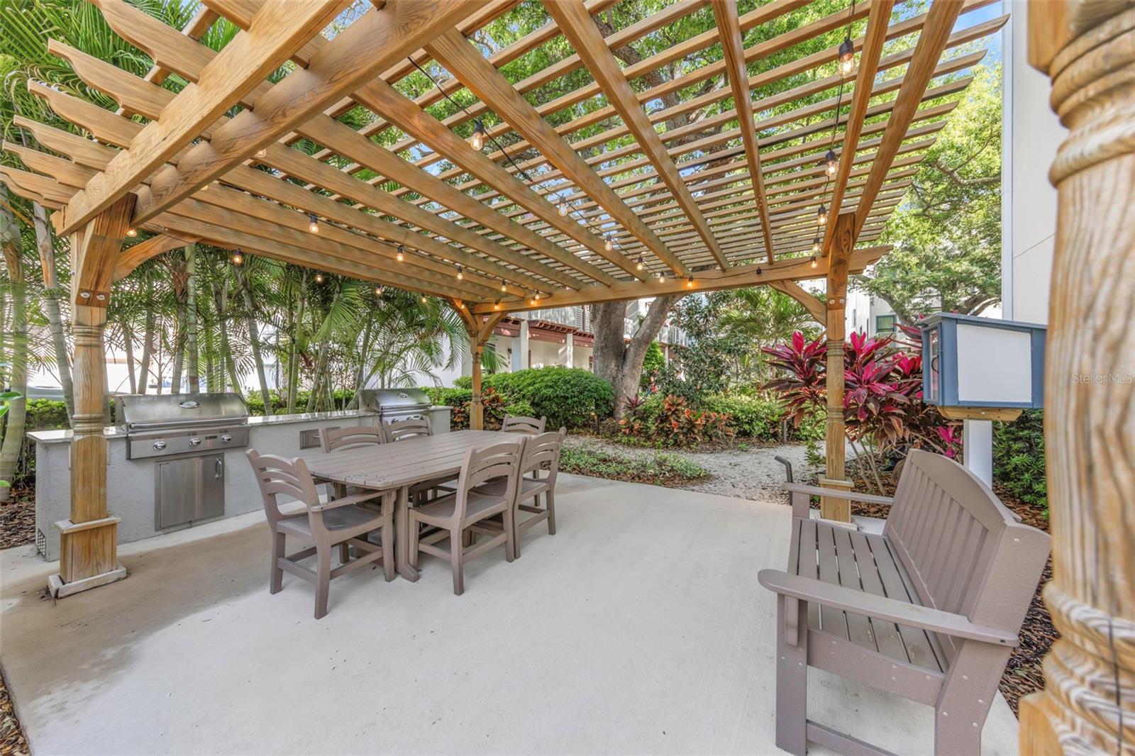 Courtyard amenities provide a terrace-covered dining and seating area.