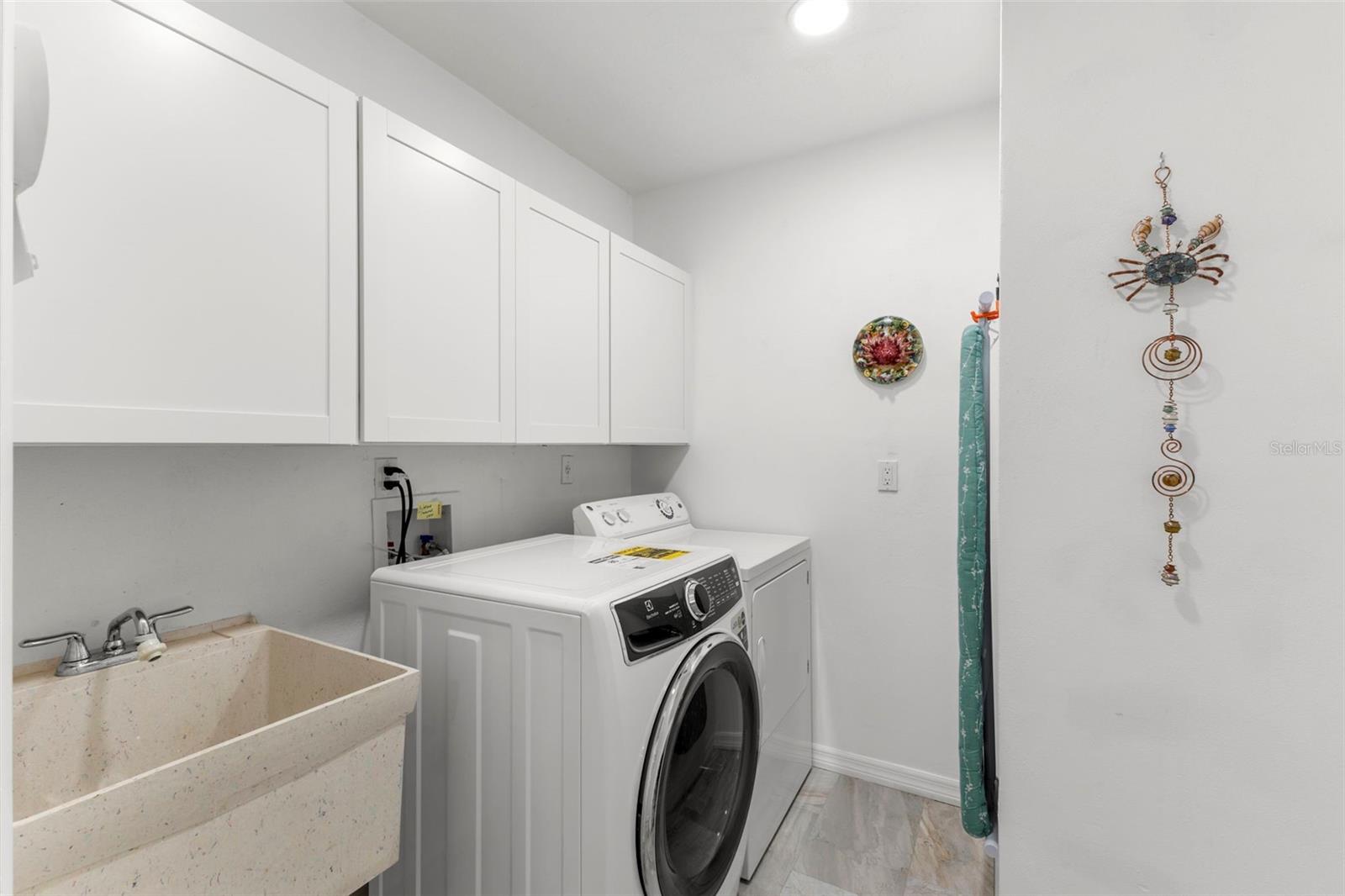 LAUNDRY ROOM WITH LOTS OF STORAGE WITH UTILITY SINK AND UPDATED WASHER AND DRYER