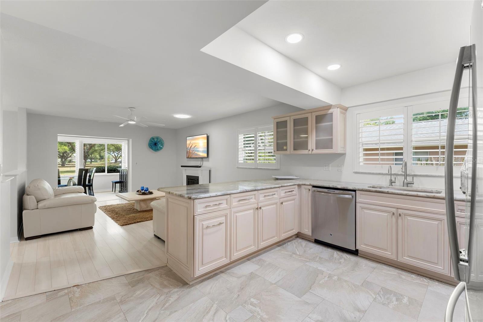 KITCHEN LOOKING OUT TO FAMILY TV ROOM AND BACK PORCH. VIEW OF FAIRWAY IN EVERY ROOM