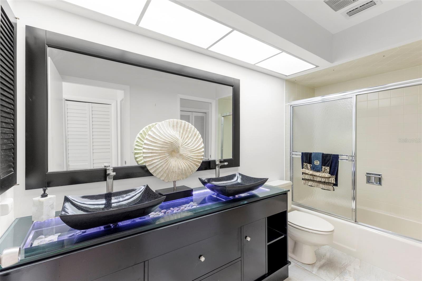 GUEST BATHROOM WITH BEAUTIFUL LIGHTING, BATHROOM WITH SHOWER AND BATH AND STORAGE