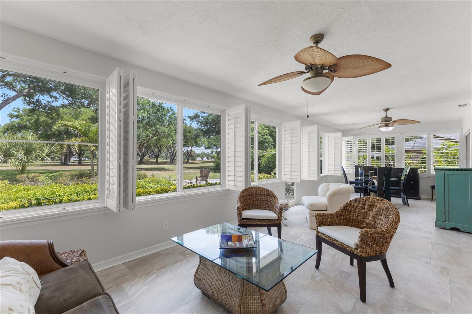 BACK PORCH WITH GORGEOUS VIEW OF FAIRWAY AND LOTS OF SITTING AREAS