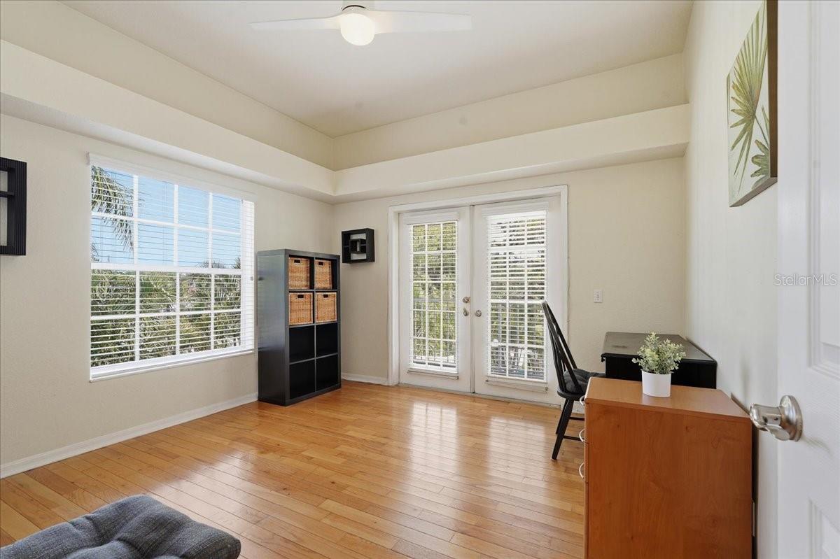 2ND STORY BEDROOM/OFFICE WITH ACCESS TO THE BACK BALCONY OVERLOOKING THE POOL