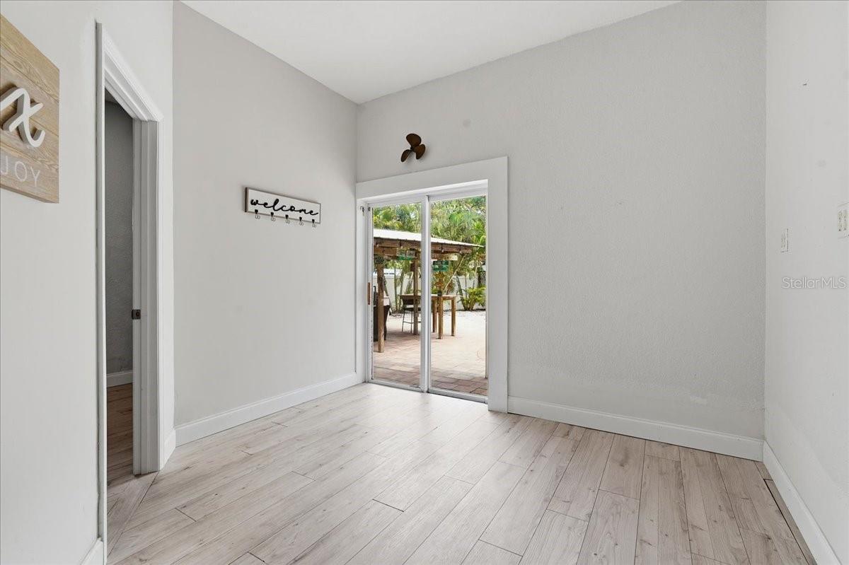 SLIDING GLASS DOORS OUT TO POOL AREA