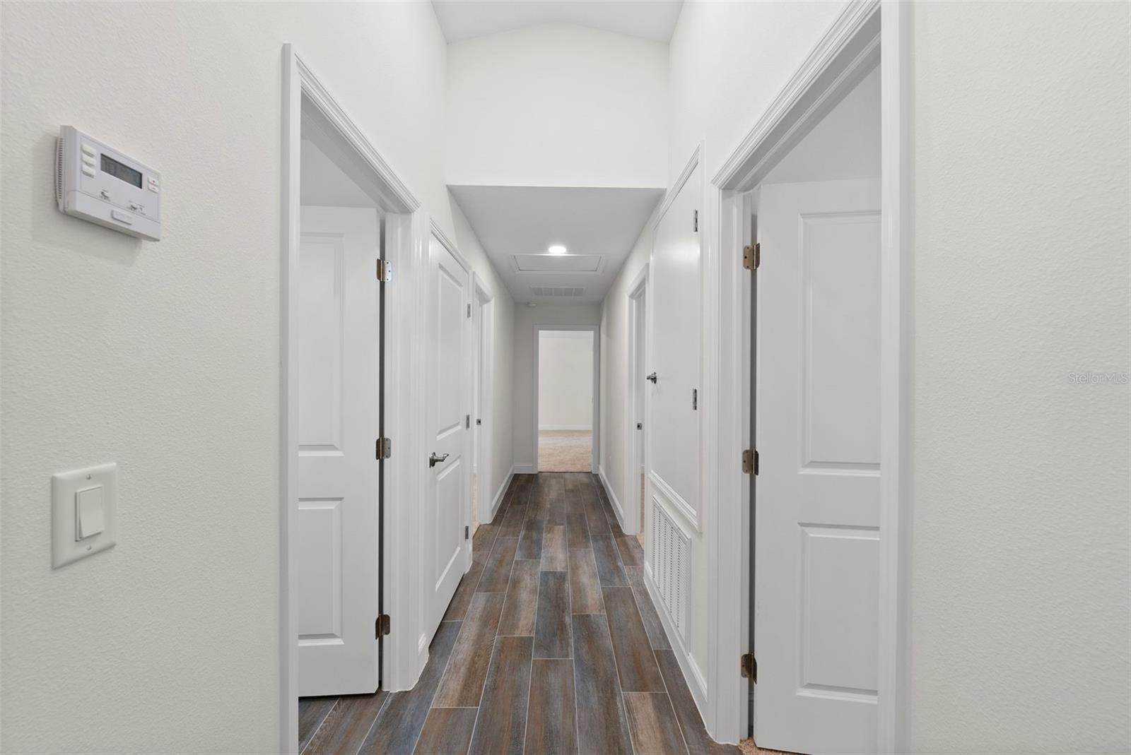 Hallway: Left Side - 2nd Full Bathroom, Laundry Closet, Bedroom 2; End of Hallway - Entrance to Primary Bedroom & Ensuite Bathroom; Ridht Side - Bedrooms 3 & 4