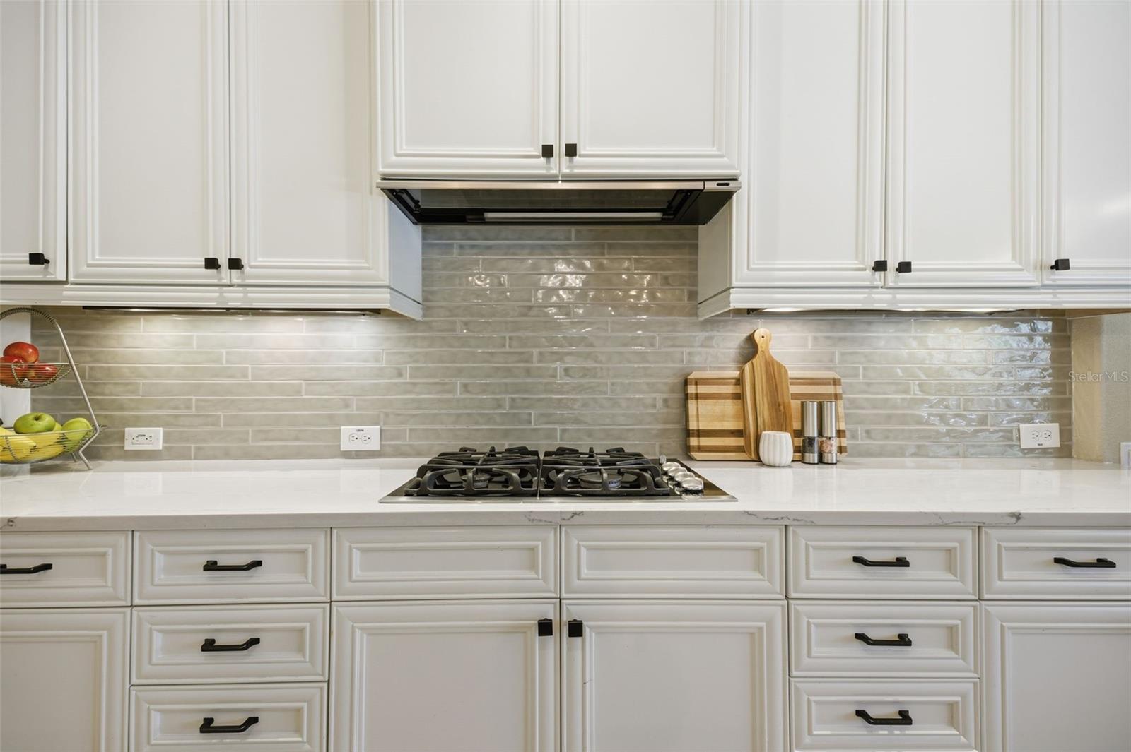 Fresh new backsplash and quartz counters.