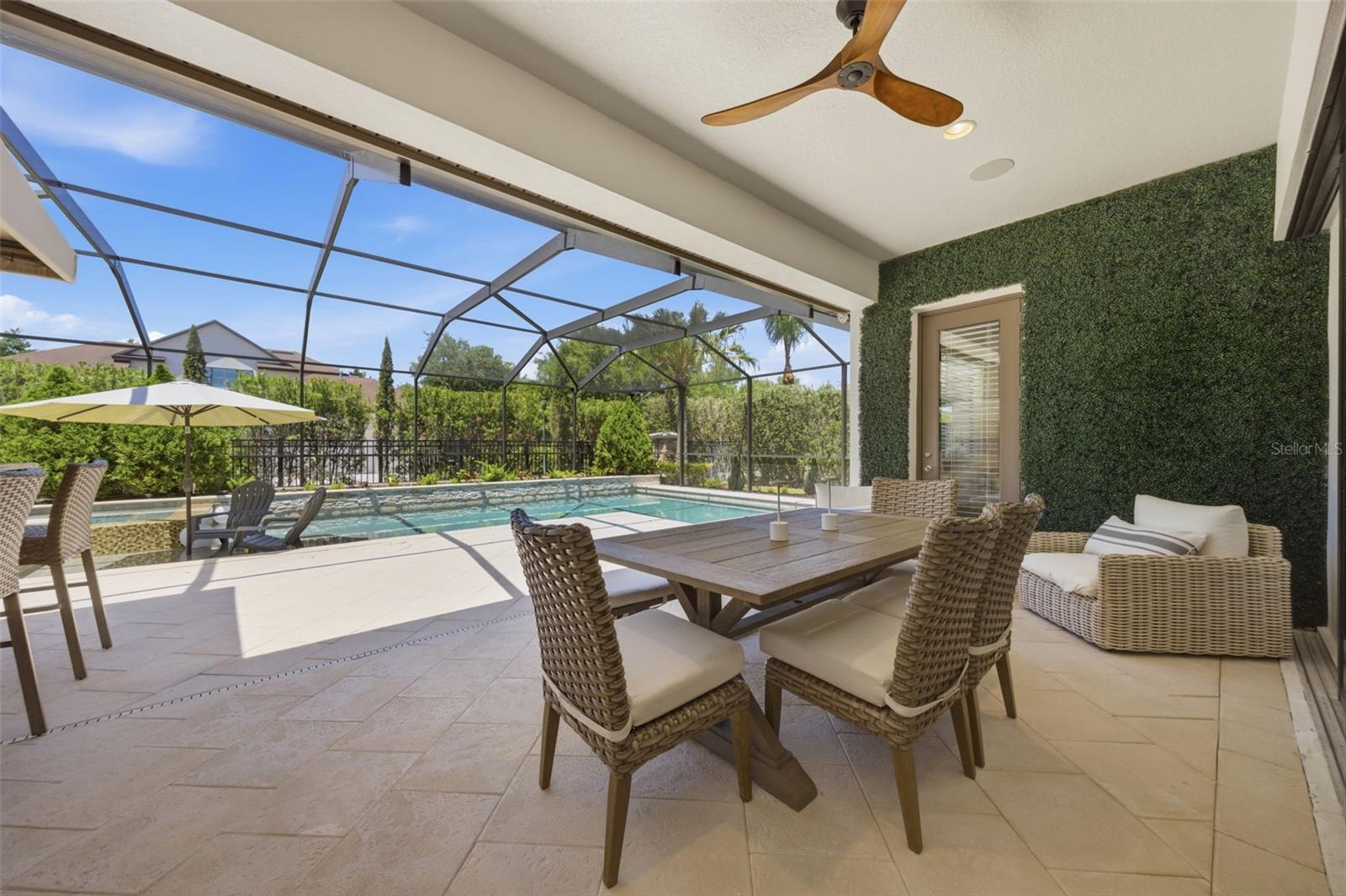 Outdoor covered seating area with green wall.