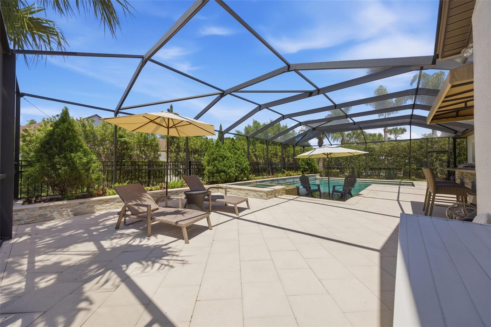 Spacious paver area on pool deck.