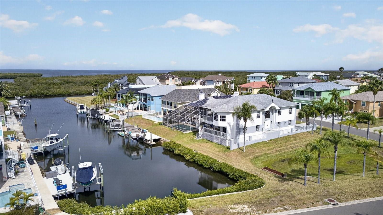 View of deep channel to Gulf behind home and large corner lot