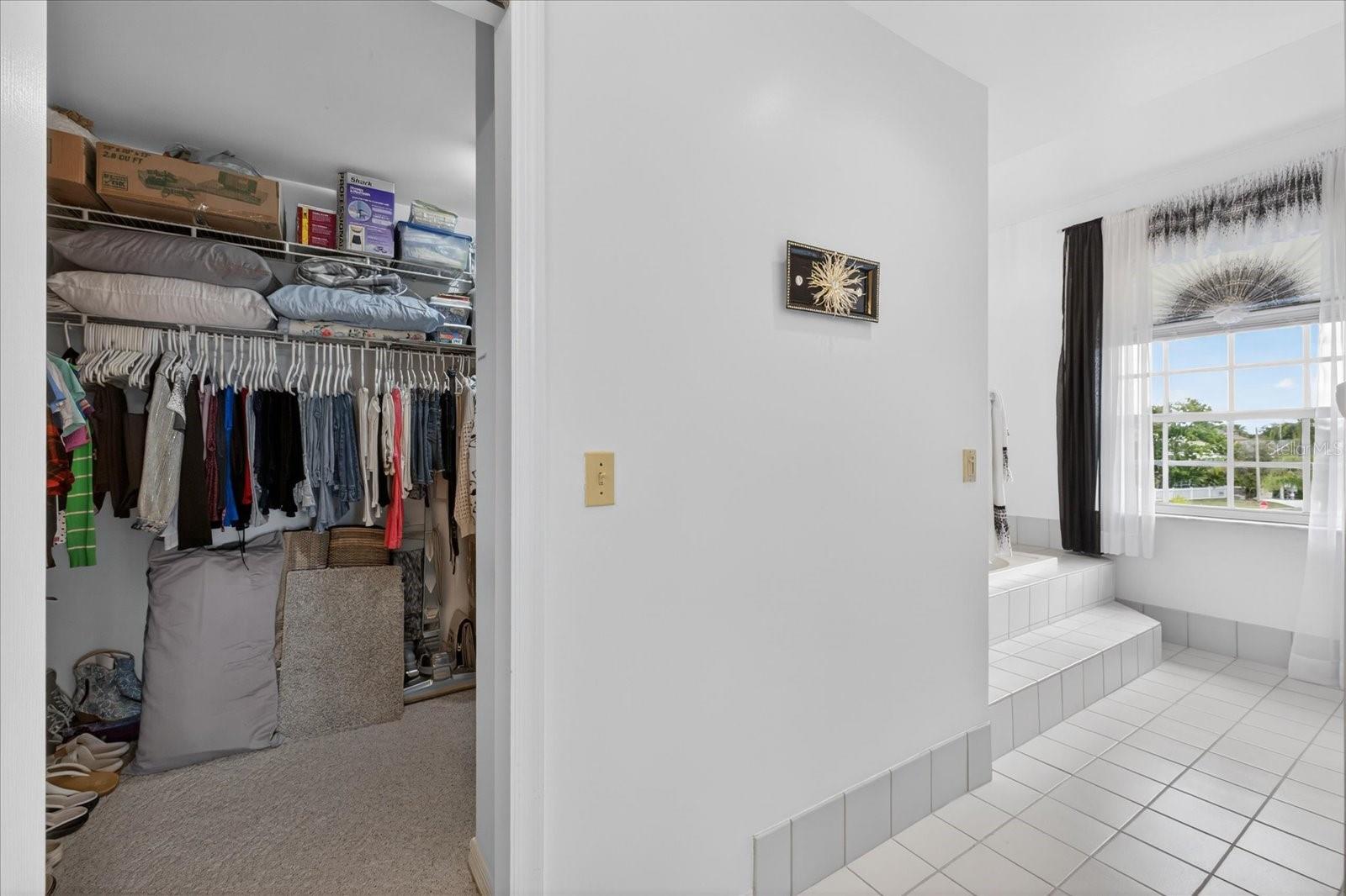 Large walk in closet with laudry chute to lower level laundry room.