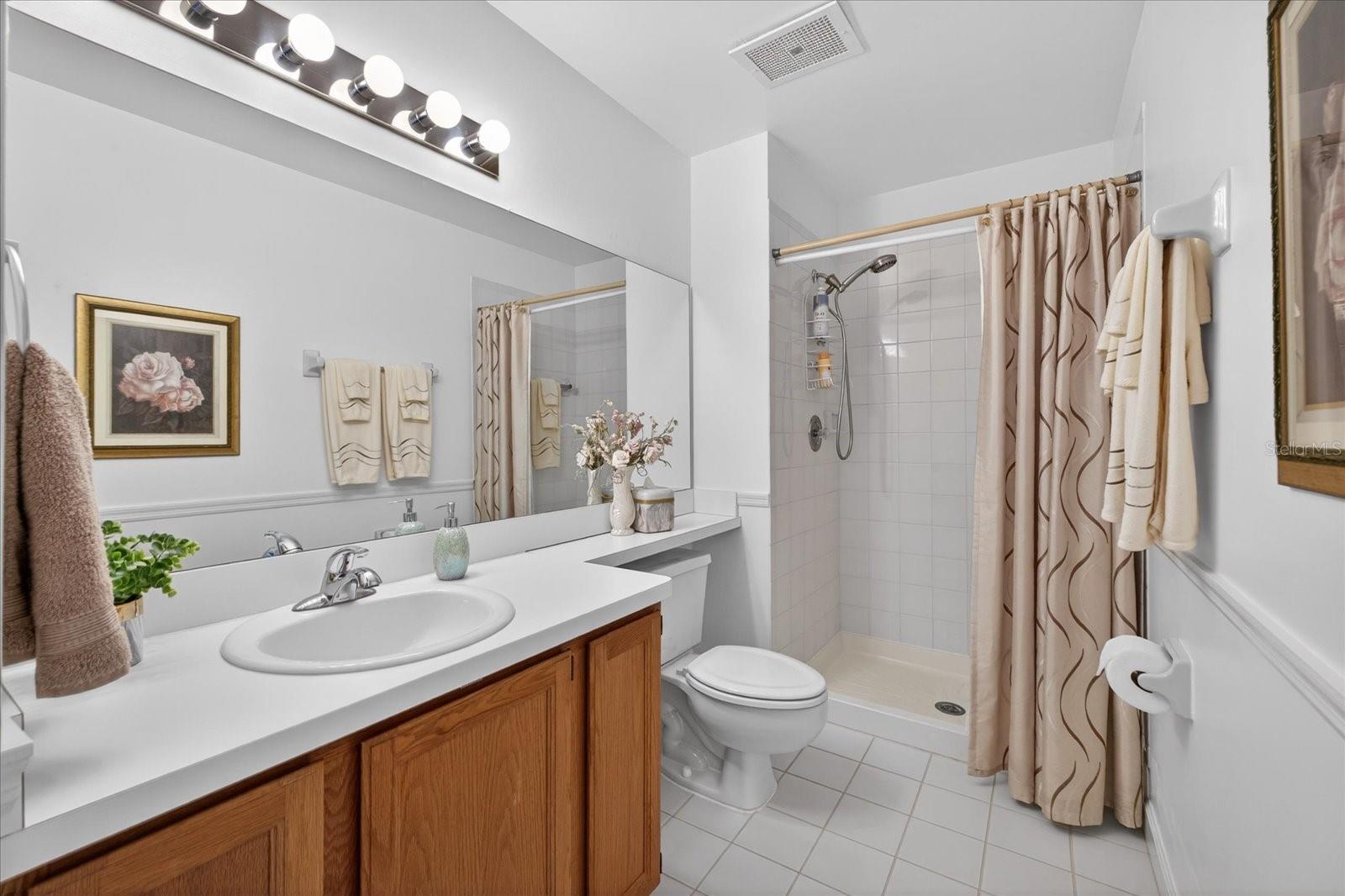 Guest bathroom upper level with linen closet.