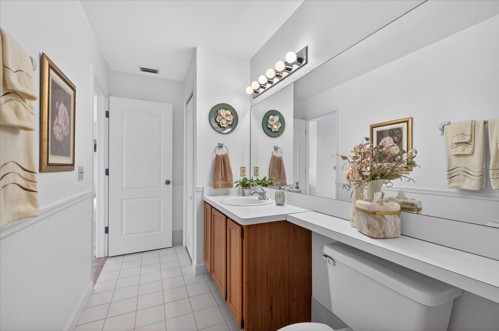 Guest bathroom upper level with linen closet.