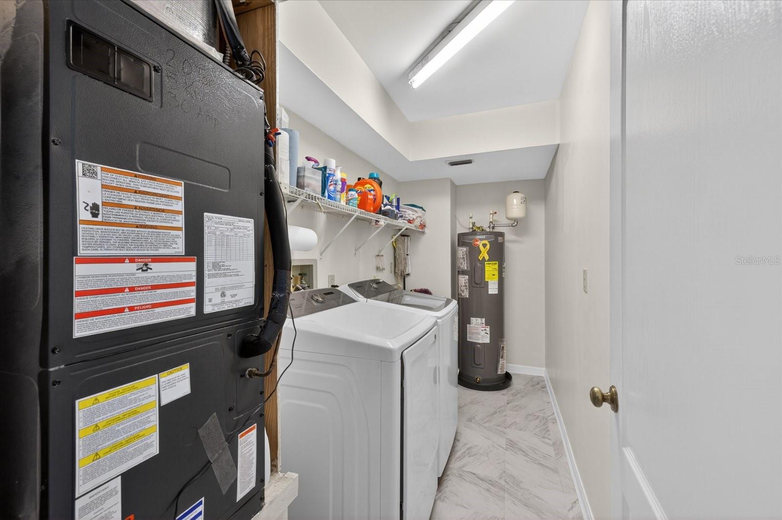 Laudry room with air handler for lower level and hot water heater