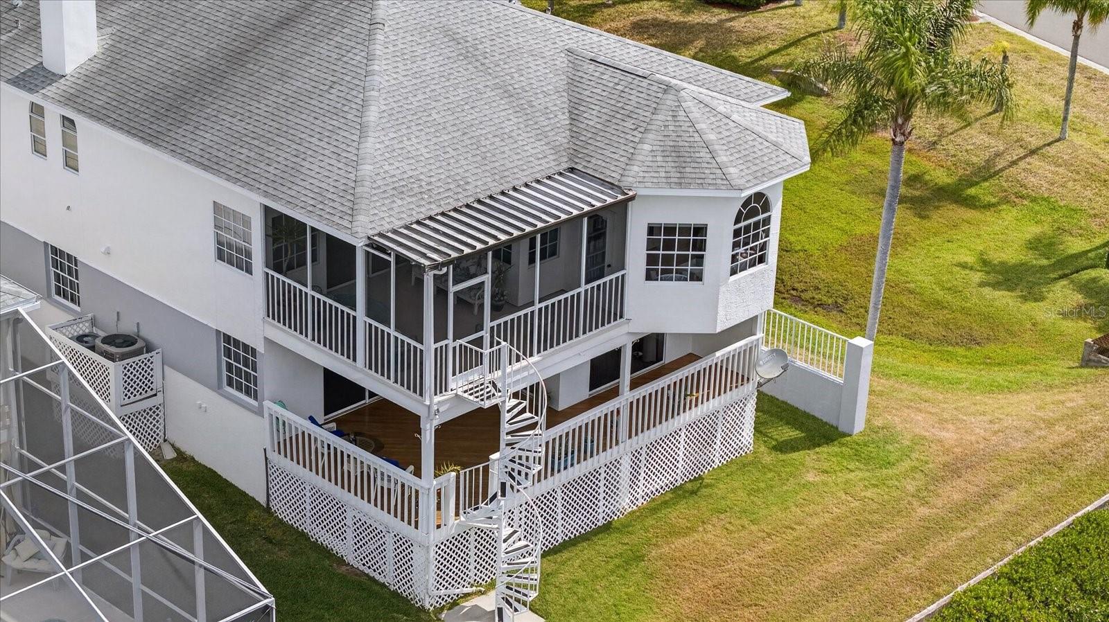 Aerial view of both balconies and alcove and backyard of home
