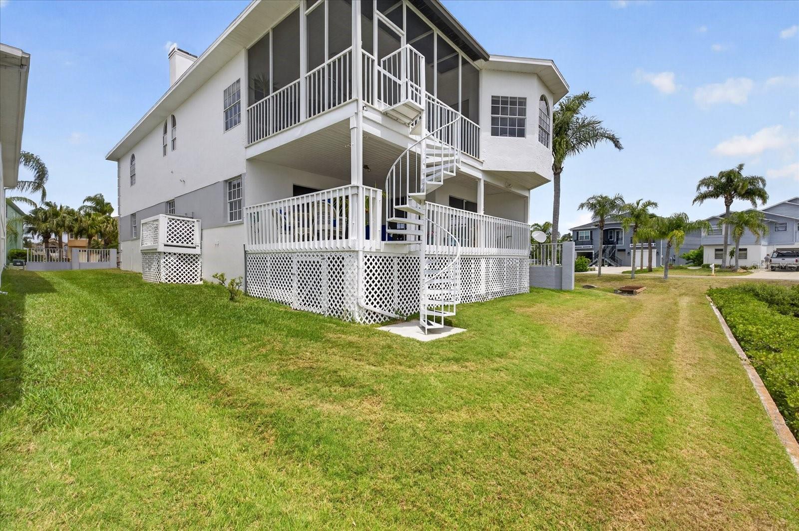 Street view of home showing side yard and AC elevated.