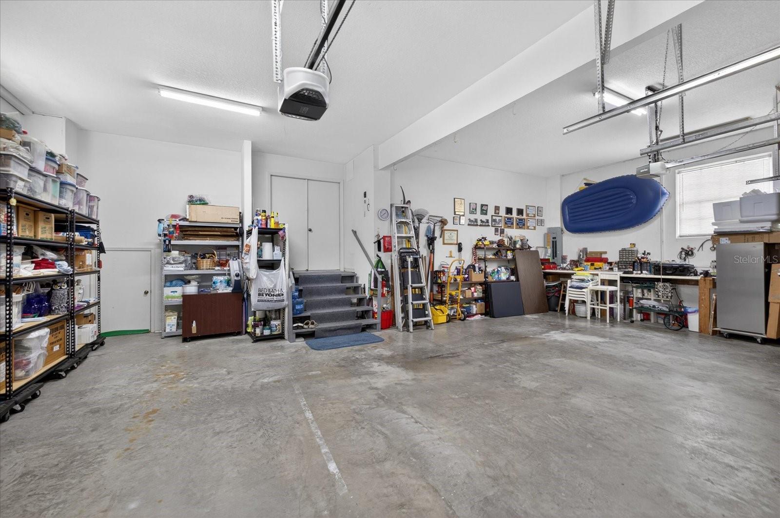 Garage with closet under stairs for water softener system storage and more!