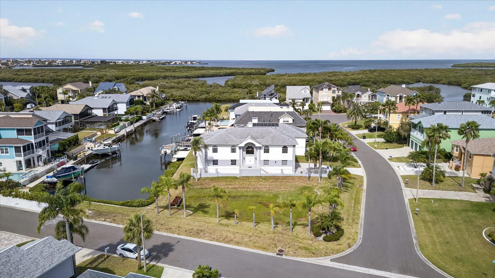 Aerial of front of home and Gulf in the distance