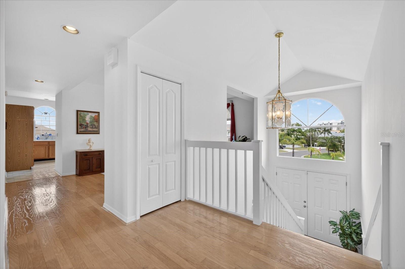 Top of stairs in main living room into dining room and kitchen