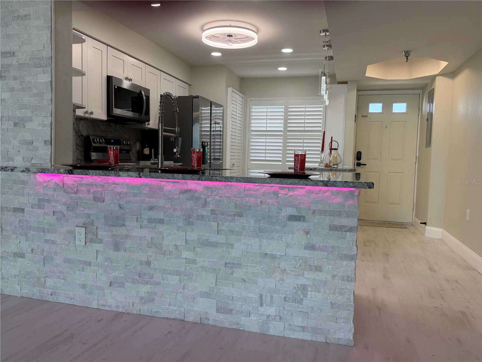 View of Kitchen and Under-counter accent lighting from Dining Room. So many color to choose from!