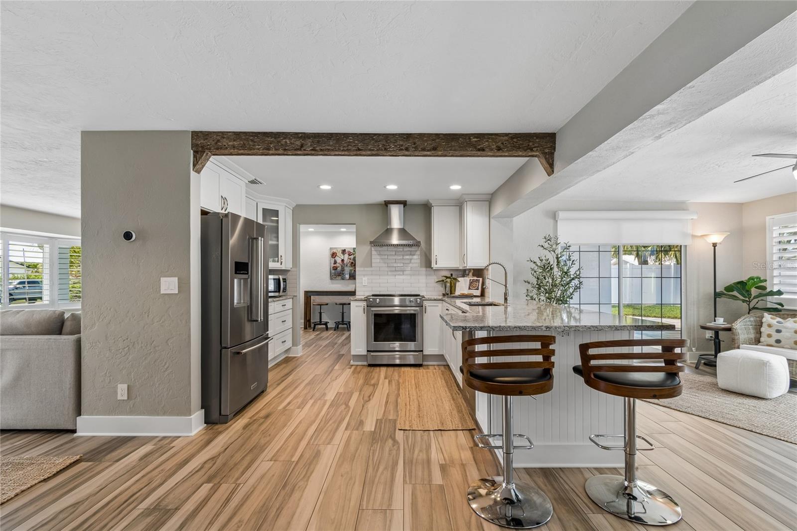 Open layout with cypress beam, kitchen centerpiece