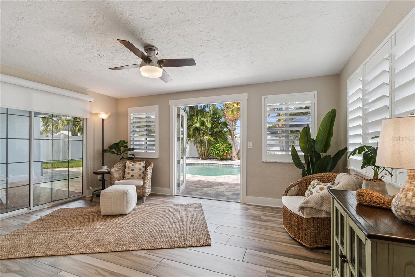 Living spaces open to covered lanai and pool