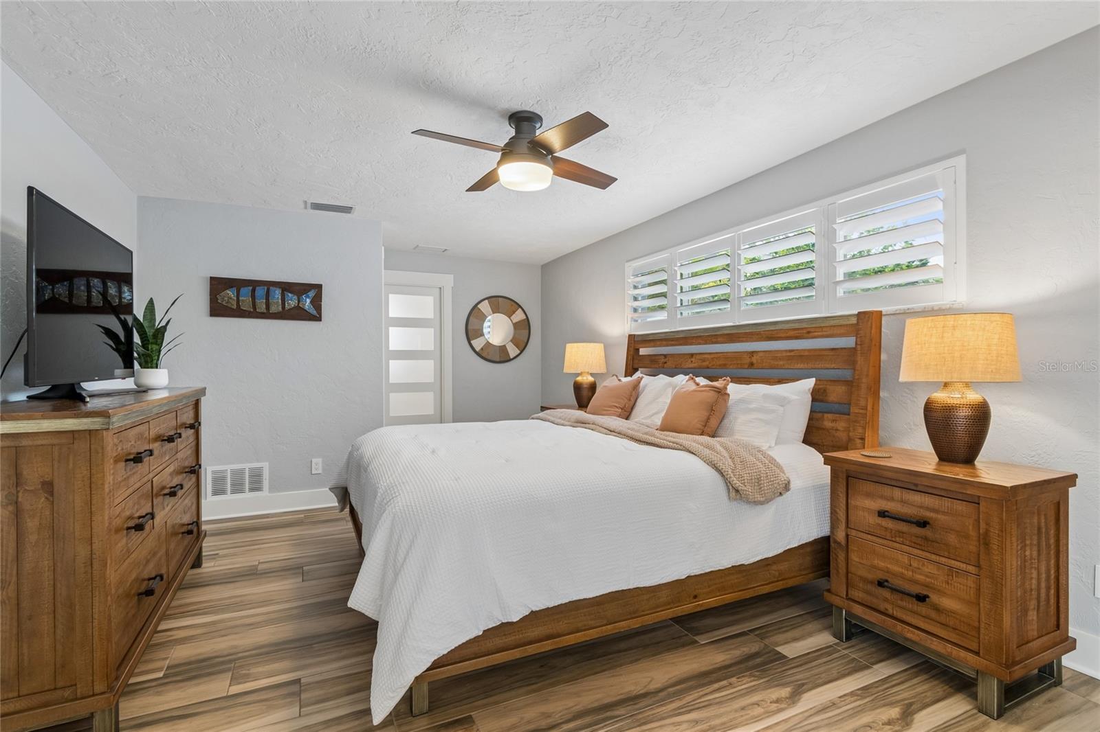 Primary suite with serene tones, custom shutters