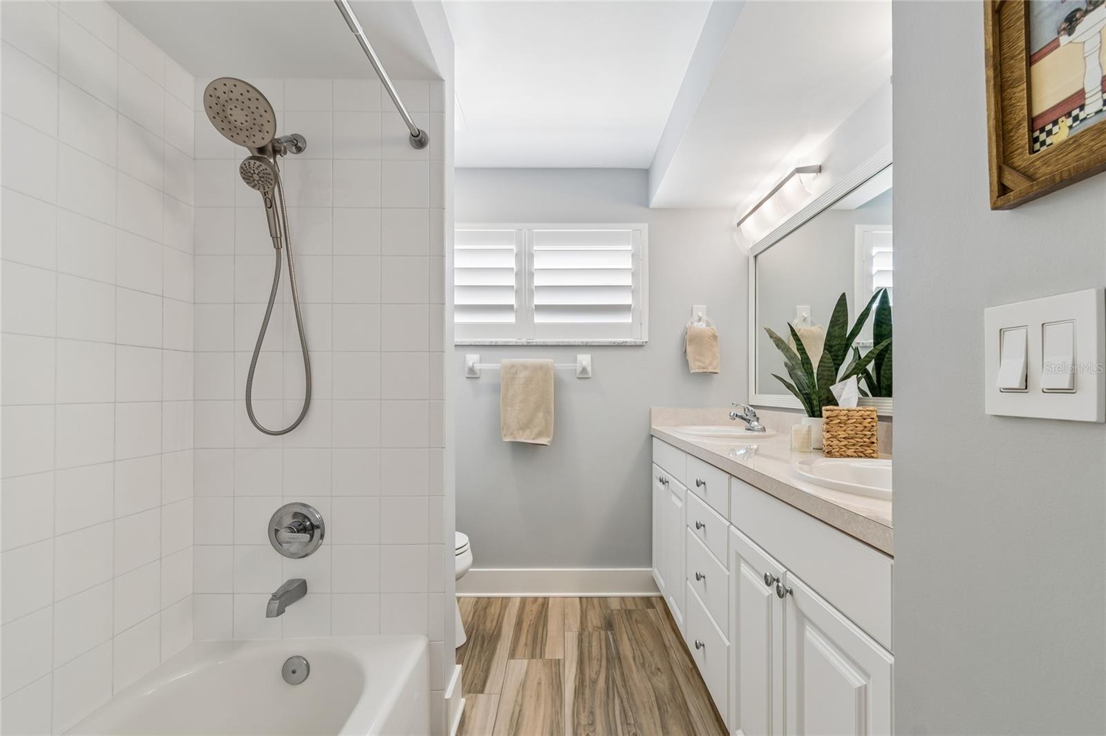 Guest bath, tub-shower, double sinks, natural light