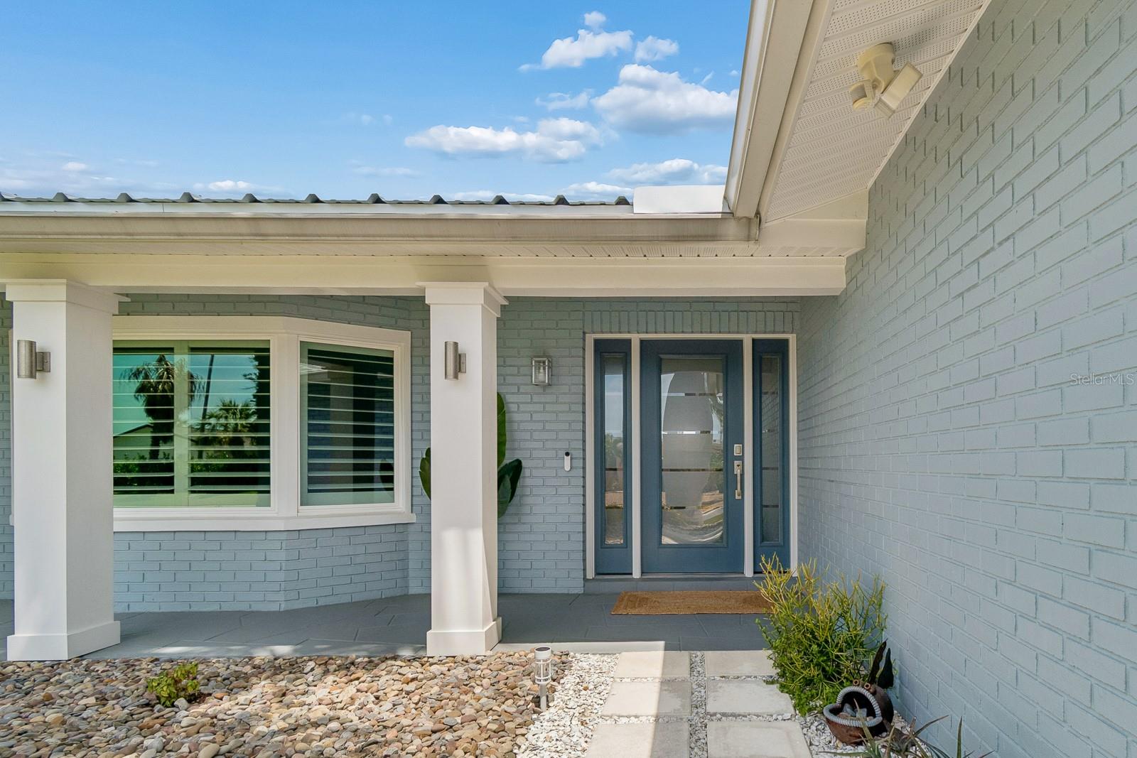 Welcoming covered entry with columns