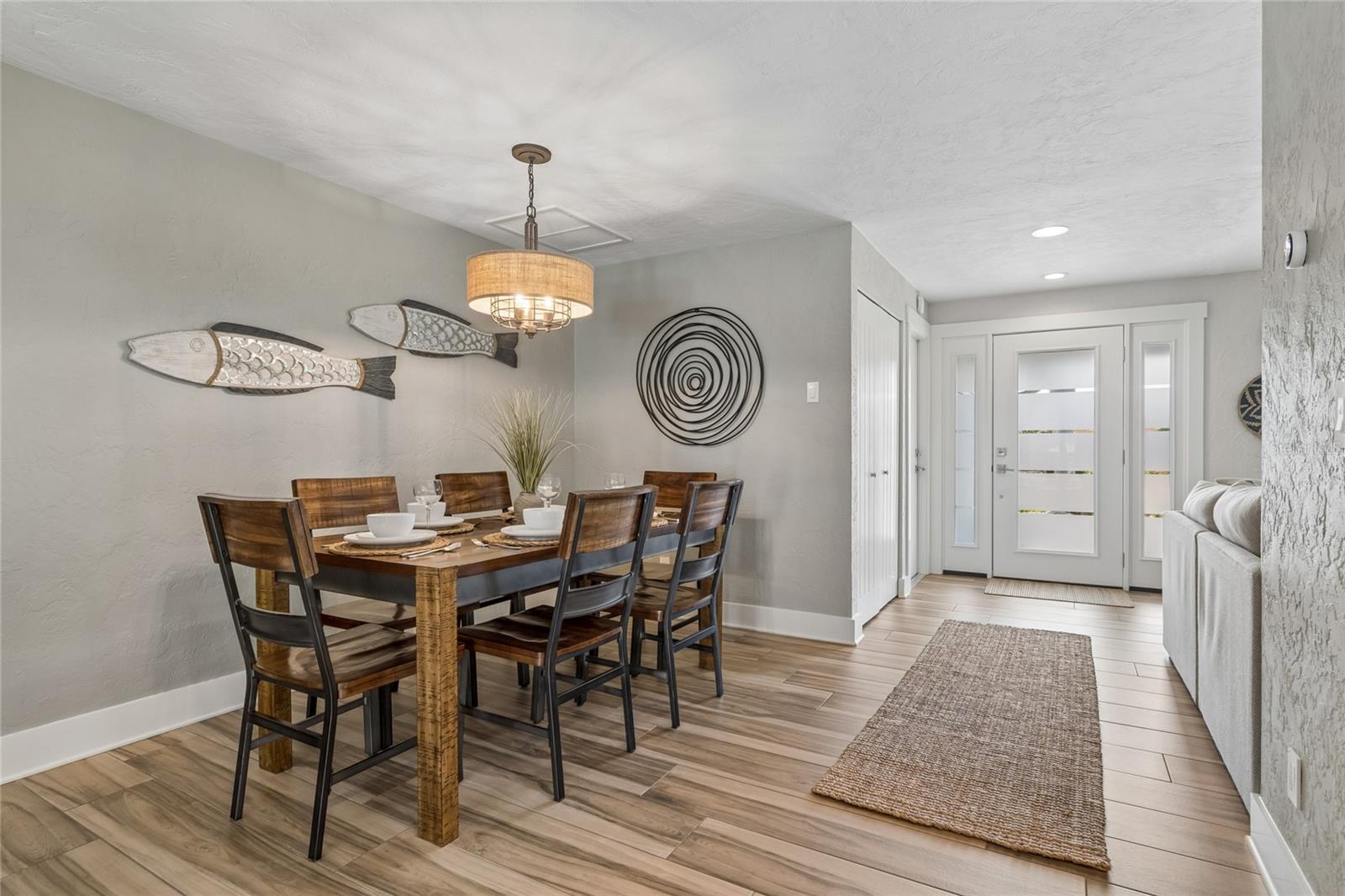 Coastal dining with designer lighting, open flow