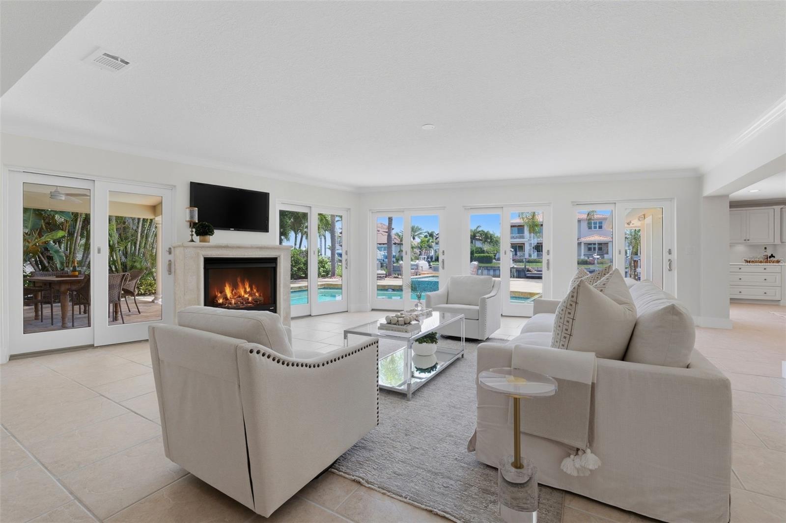 Living room with gas fireplace and sliders to pool
