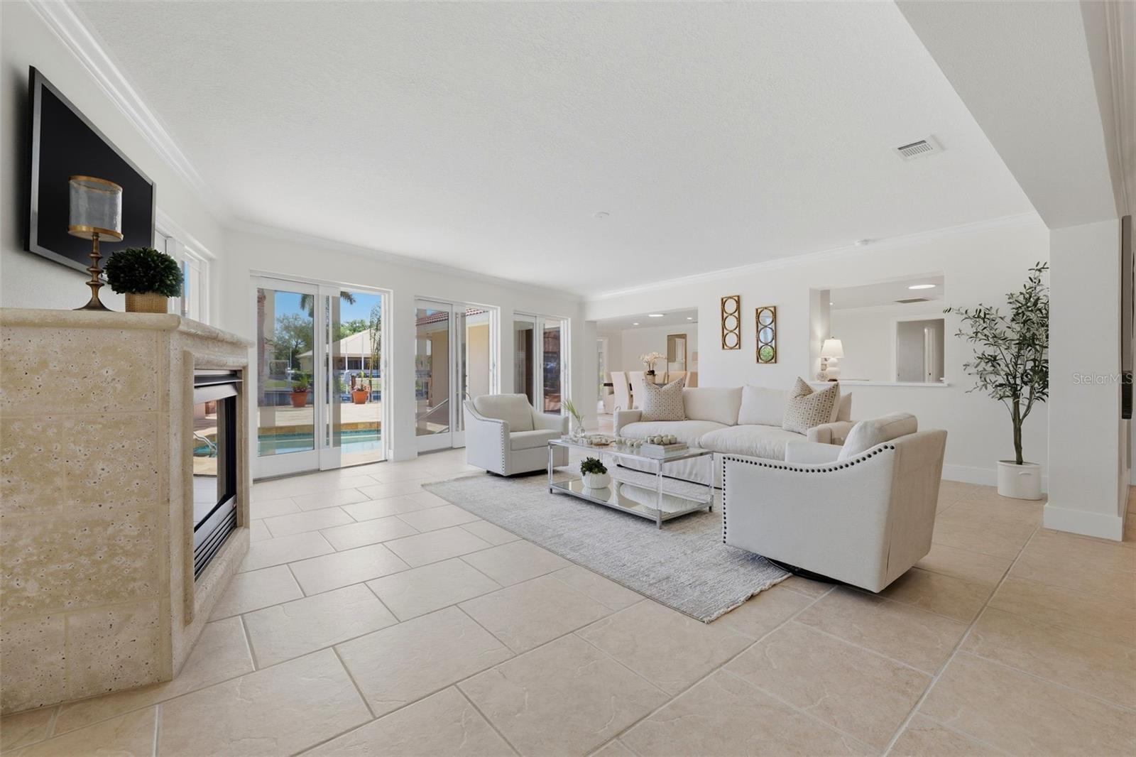 Living room with gas fireplace and sliders to pool