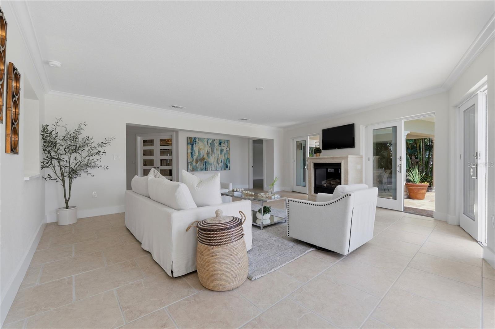 Living room with gas fireplace and sliders to pool