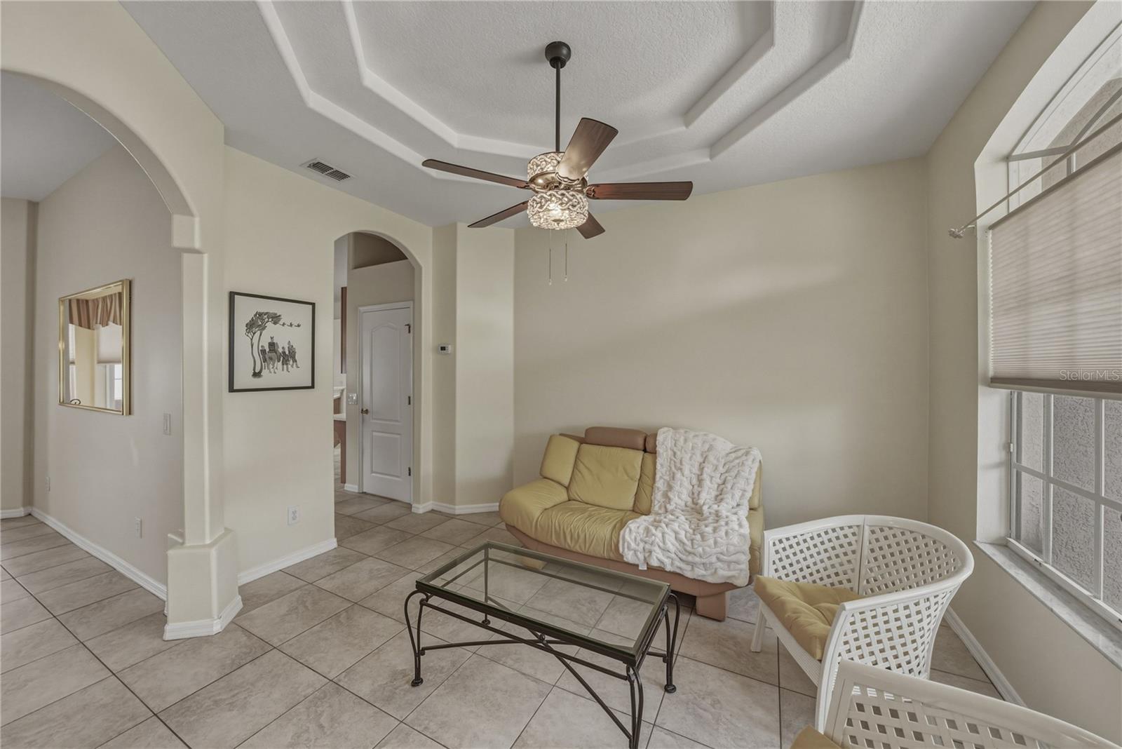 A versatile front room ideal for a home office, sitting area, or stylish space to gather and entertain.