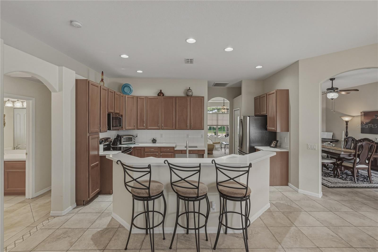 Bright, open-concept kitchen flowing into a cozy breakfast nook and spacious family room, perfect for everyday living and entertaining.