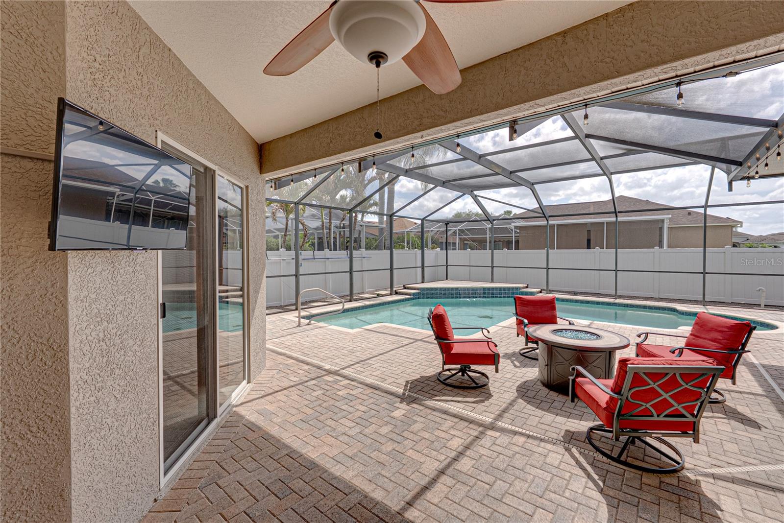 Expansive outdoor living with a large lanai, pool, and lounge area, all set in a low-maintenance backyard designed for effortless Florida living and entertaining.