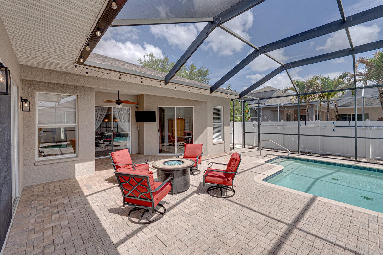 Expansive outdoor living with a large lanai, pool, and lounge area, all set in a low-maintenance backyard designed for effortless Florida living and entertaining.