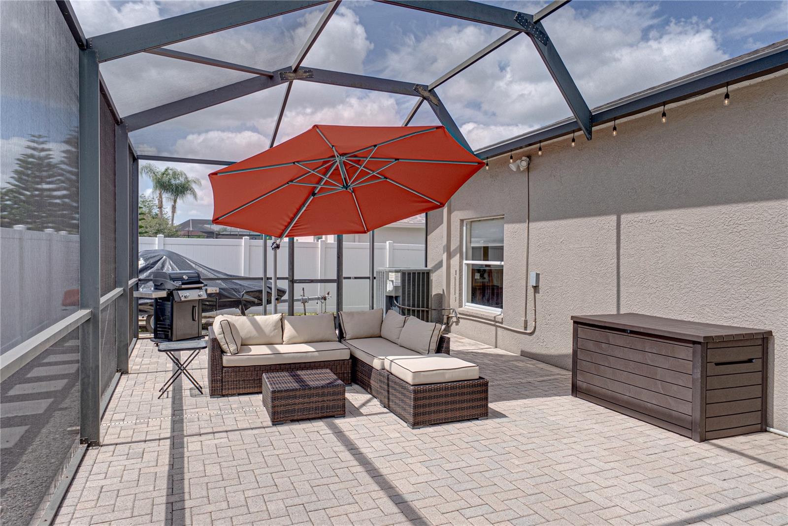 Expansive outdoor living with a large lanai, pool, and lounge area, all set in a low-maintenance backyard designed for effortless Florida living and entertaining.